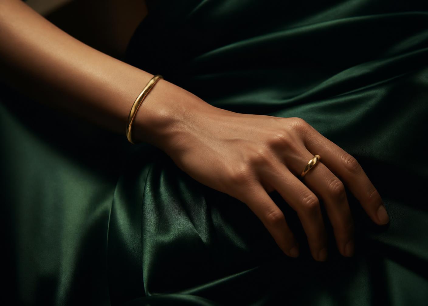 Detail of gold jewellery against emerald silk
